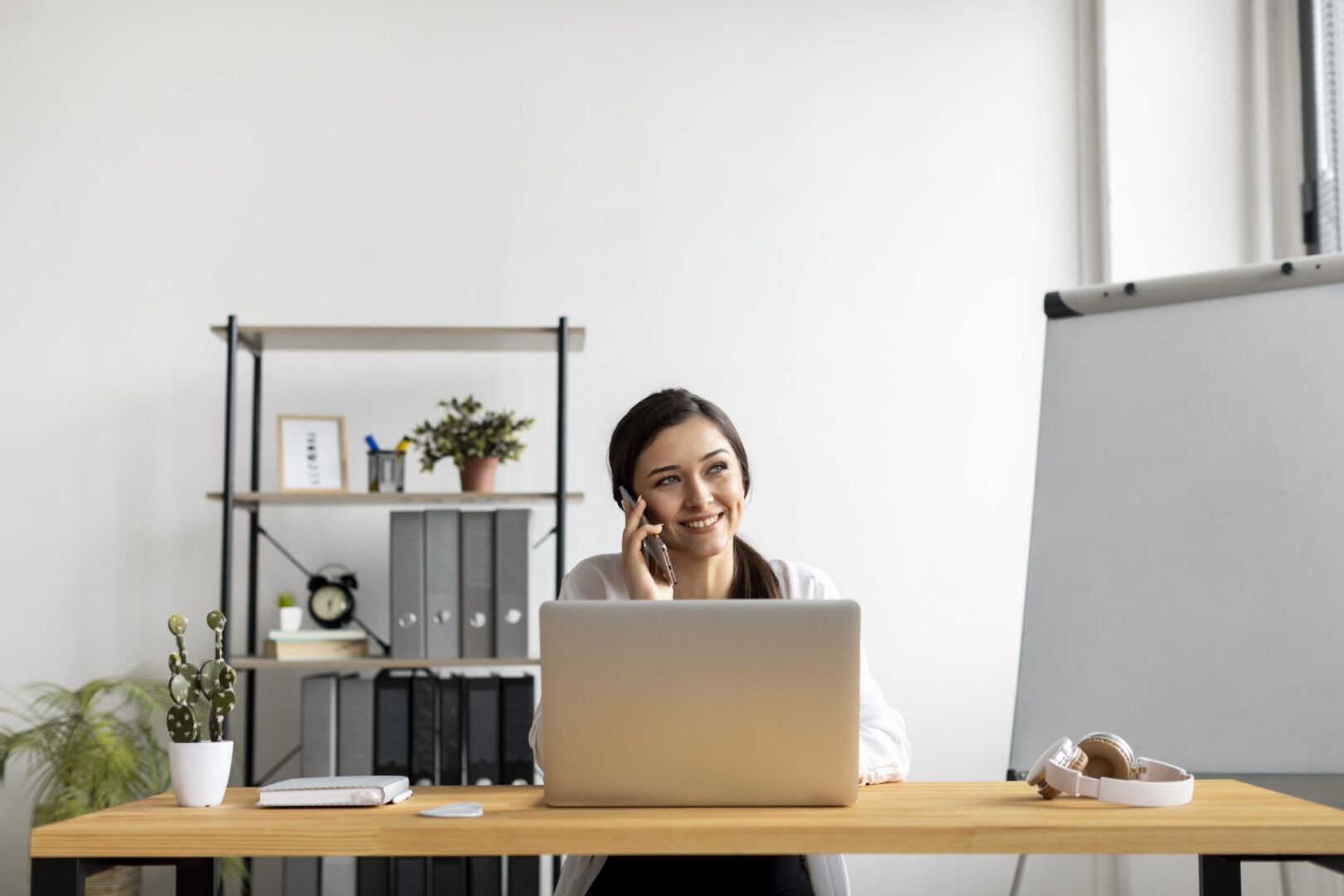 medium-shot-smiley-woman-talking-phone-min-scaled.jpg